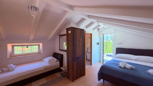 a bedroom with two beds and a window at Olive Grove House in Ston