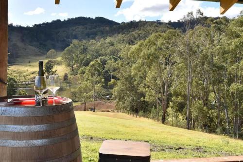 a wine barrel with a glass of wine and a view at The Glass Ceiling 360 degree Mount View Hideaway in Mount View