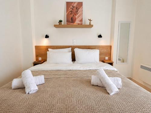 a bedroom with a large bed with towels on it at Thea Stays in Kato Gouves