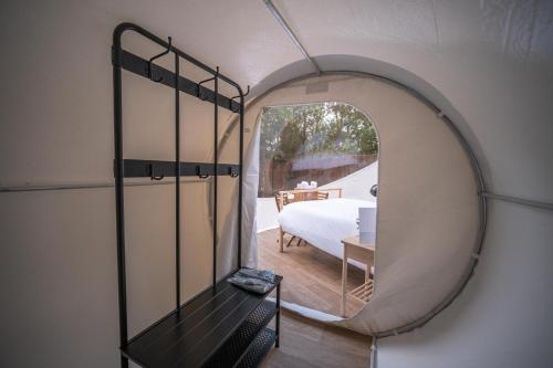 a round room with a bed and a mirror at Burbujas a las puertas de Andorra in Argolell