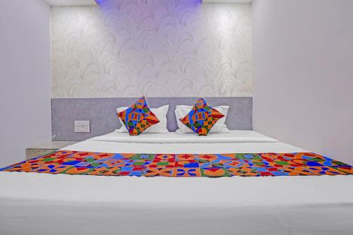 a bedroom with a bed with a colorful pattern at FabHotel Sky Inn I in Ahmedabad