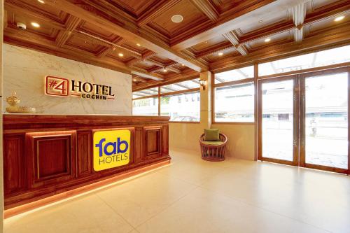 a hotel lobby with a hilton hotel sign on the wall at FabHotel Prime Hash Four in Ernakulam