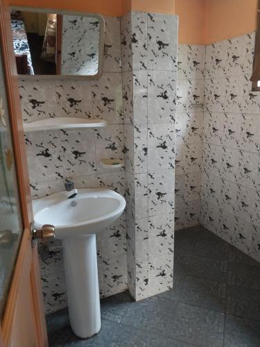 a bathroom with a sink and a mirror at Miriswaththa resort in Deniyaya