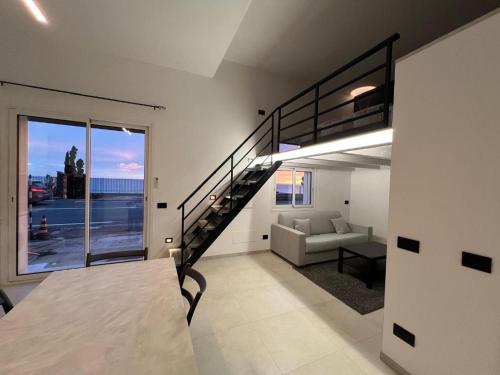 a living room with a loft bed and a couch at Vista Mare in Cipressa