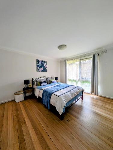 a bedroom with a bed and a wooden floor at Star House in Mitcham
