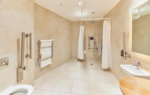 a bathroom with a shower and a toilet and a sink at The Grand, York in York