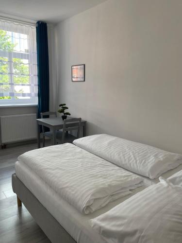 a bedroom with a bed and a table and a window at Apartman cheb in Cheb