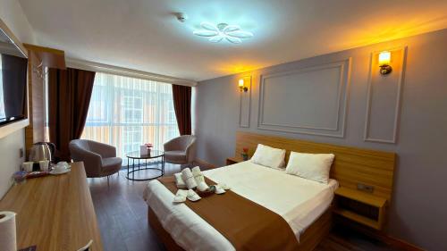 a hotel room with a large bed and a desk at Waves hotel in Avcılar
