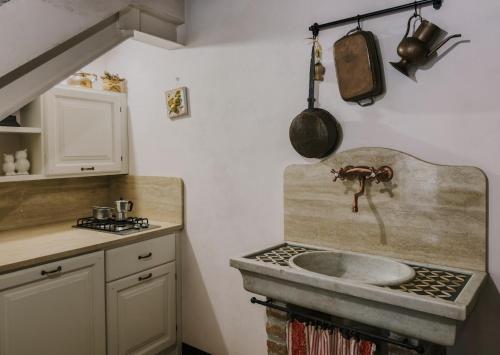 a kitchen with a sink and a stove top oven at Casa Mia A Cortona in Cortona