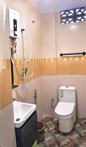 a bathroom with a toilet and a sink at Hotel Lii View in Mersing