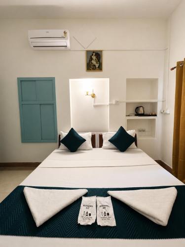 a bedroom with a bed with two towels on it at Inka Kashi Hostel Varanasi in Varanasi