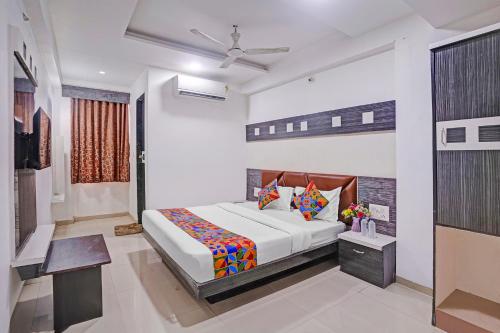 a bedroom with a bed in a room at FabHotel AGM in Ahmedabad