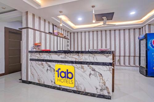 a table in a room with a sign on it at FabHotel AGM in Ahmedabad