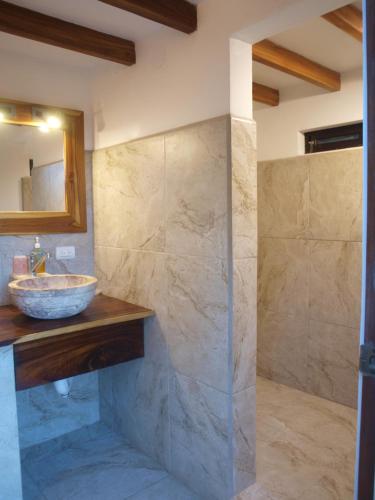 a bathroom with a sink and a mirror at Lodge Margouillat in Tambor