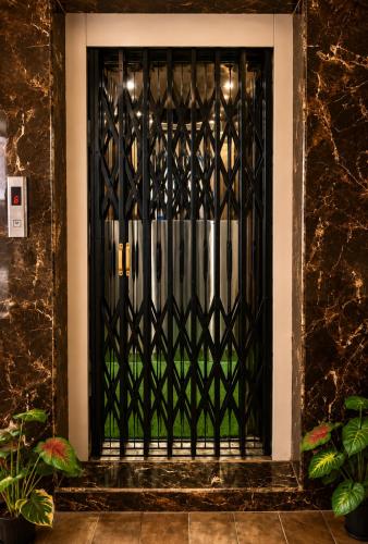 a black door with a black iron gate at Hotel KK Grand in Guntūr