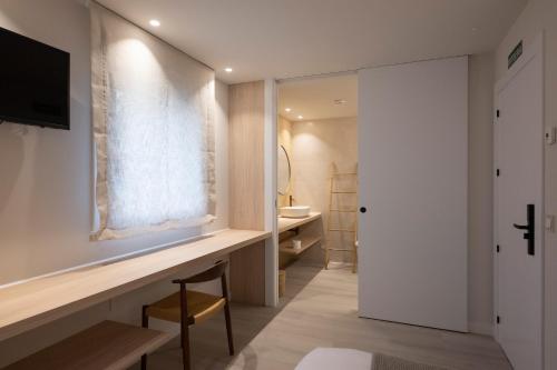 a bathroom with a desk and a window and a sink at Kamiñone Landetxea in Beasain