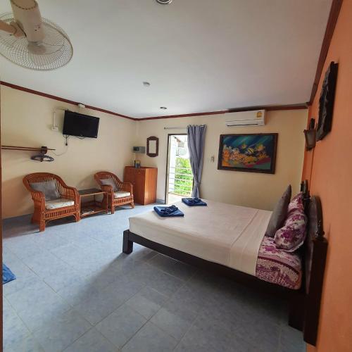 a bedroom with a bed and a tv in it at Seaworld Guesthouse in Ao Nang Beach