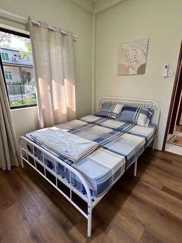a bedroom with two beds and a window at Permaisuri homestay in Bintulu