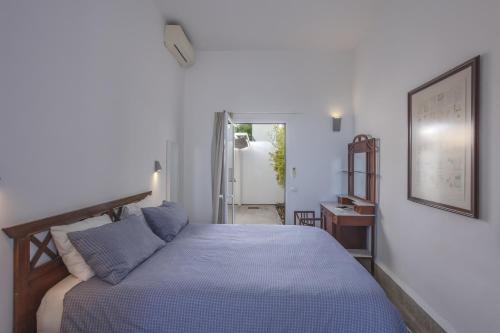a bedroom with a bed with a blue comforter at Casa La Breña La Palma in Breña Baja