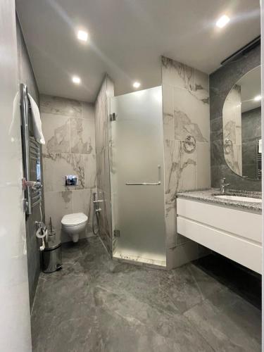 a bathroom with a shower and a toilet and a sink at Lastiver Resort in Yenokavan
