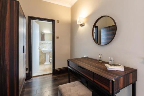 a bathroom with a wooden dresser and a mirror at 12 Bed in Bournemouth oc-t28236 in Bournemouth