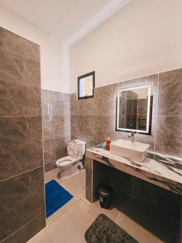 a bathroom with a sink and a toilet at Diani Dream luxury apartment in Diani Beach
