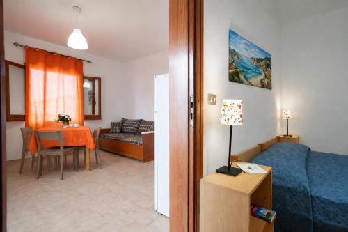 a room with a bed and a table with a dining room at Testa di Monaco - Basic Beach Accommodations in Capo dʼOrlando