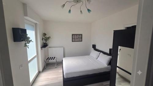 a bedroom with a white bed and a window at Bella Vita Stays Wellness in Sondrio