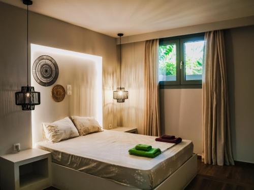 a bedroom with a large bed with a window at K Villas in Plataria