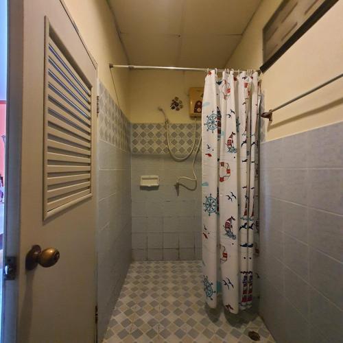 a bathroom with a shower with a shower curtain at Seaworld Guesthouse in Ao Nang Beach