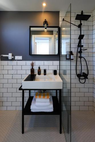 a bathroom with a white sink and a mirror at Cedori Butik Otel in Ezine