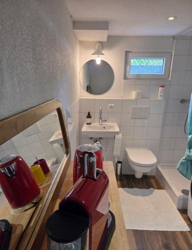 a small bathroom with a red machine in it at Charmante Waldrandidylle in Kreuzlingen