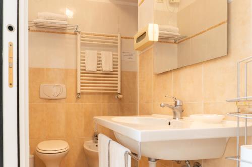 a bathroom with a sink and a toilet at Hotel Nuovo Al Mare in Alassio