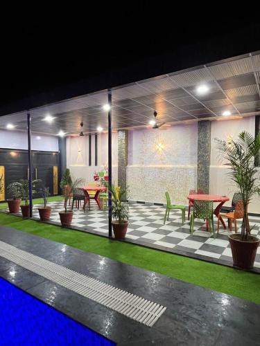 an empty patio with tables and chairs and plants at lavender hill in Jaipur