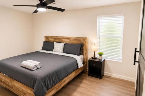 a bedroom with a bed and a ceiling fan at Cozy Contemporary Bungalow in Decatur