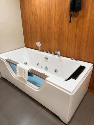 a bath tub with a sink in a bathroom at A25 Premium Hotel - 16 Miếu Đầm in Hanoi