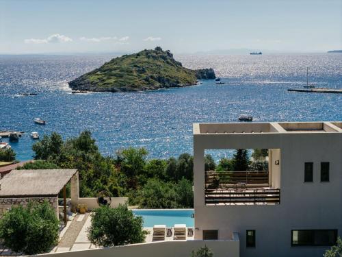 a house with a view of the water at Apaggio Luxury Villa - Private Pool & Stunning Sea Views, by ZanteWize in Agios Nikolaos