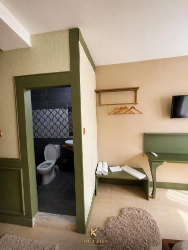 a small bathroom with a toilet and a sink at Hotel Kika in Prishtinë
