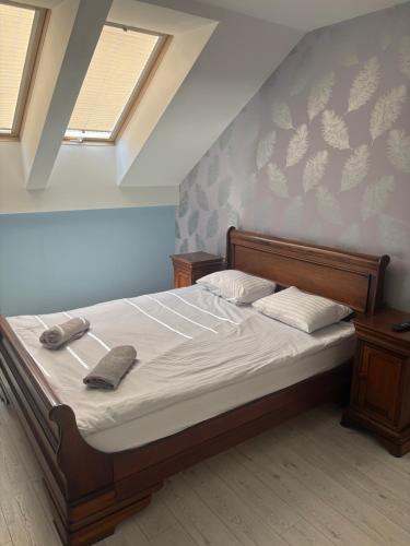 a bedroom with a bed with two towels on it at W Dolinie in Małkowice