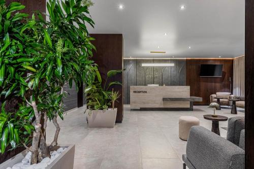 a lobby with potted plants and a reception desk at Villa Elena SPA & Resort in Bukovel