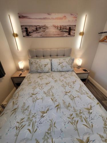 a bed in a bedroom with two night stands at Rose Cottage Clonmel in Clonmel
