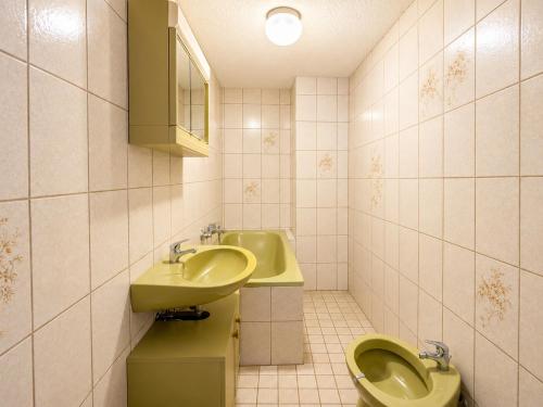 a bathroom with two toilets and a sink at Workers House in Bockenem