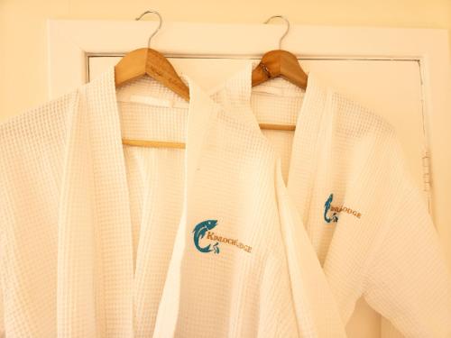 a white robe is hanging on a hanger at Kinloch Lodge in Drumnadrochit