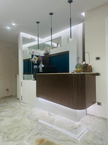 a lobby with a counter with blue and white at Hotel Perla Dello Ionio in Torre Lapillo