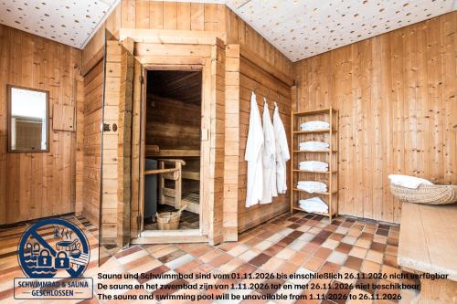 a room with wooden walls and a closet with towels at Ferienwohnung Talblick in Schmallenberg