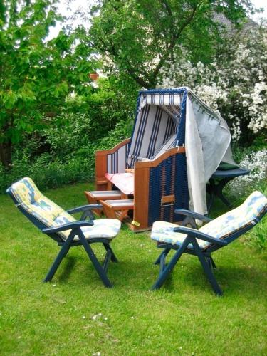 two chairs and a play structure in the grass at Wichmann, Ursula & Axel in Schönberg