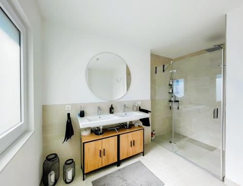 a bathroom with a sink and a shower at 3S Holiday Home in Traunstein