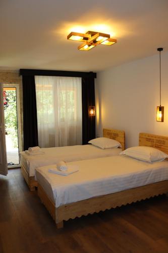 a bedroom with two beds and a window at La Brazi by BMD in Vulcan