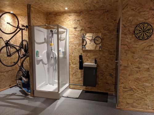 a bathroom with a shower and a bike on the wall at 1860 Bordeaux - Lormont house in Lormont
