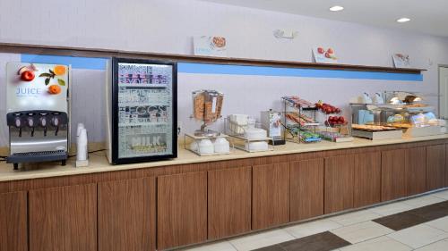 a counter in a restaurant with a food counter at Holiday Inn Express & Suites Lexington Midtown - I-75 by IHG in Lexington